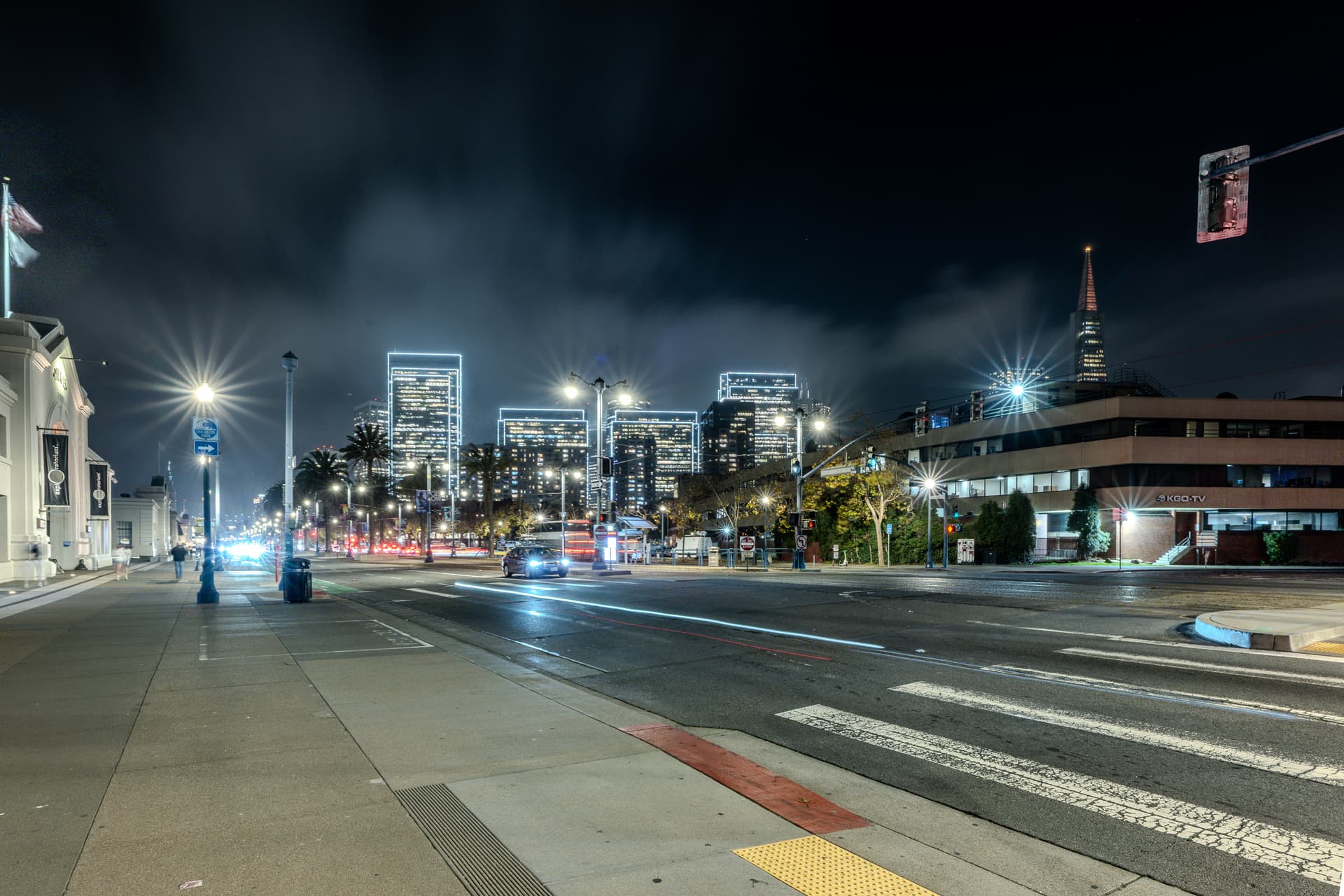 Night view along the Embarcadero near the Exploratorium with illuminated San Francisco towers and streetlights