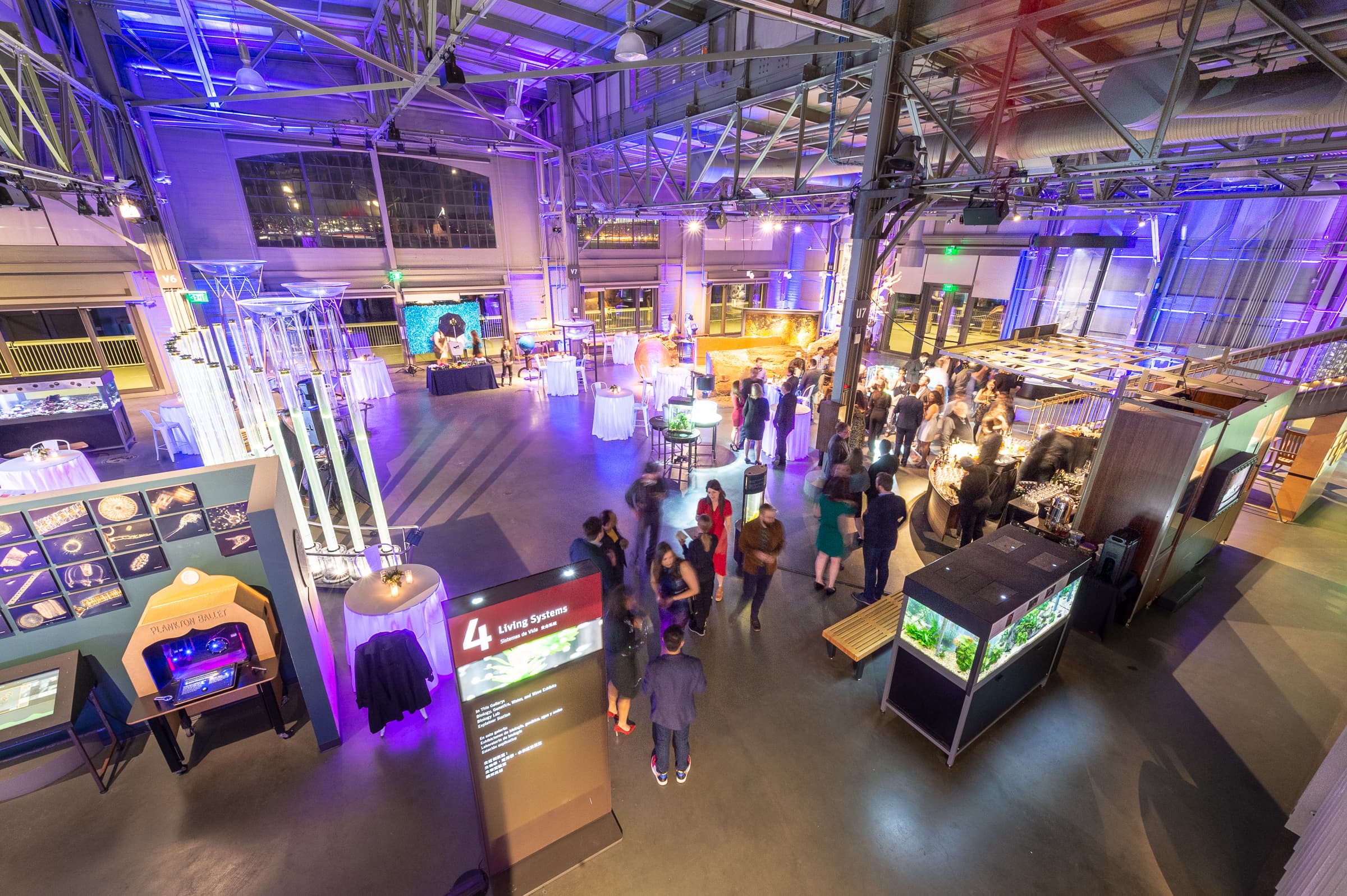 Wide view of a science museum floor set for an evening event