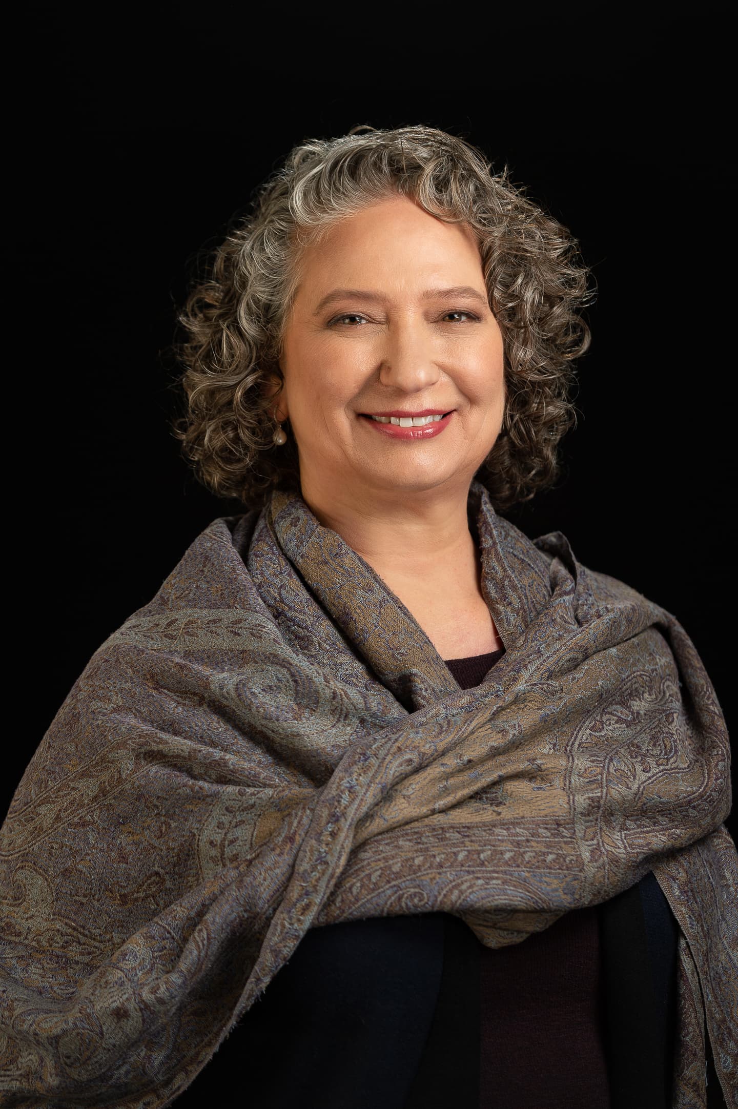Dramatic portrait of woman against black background