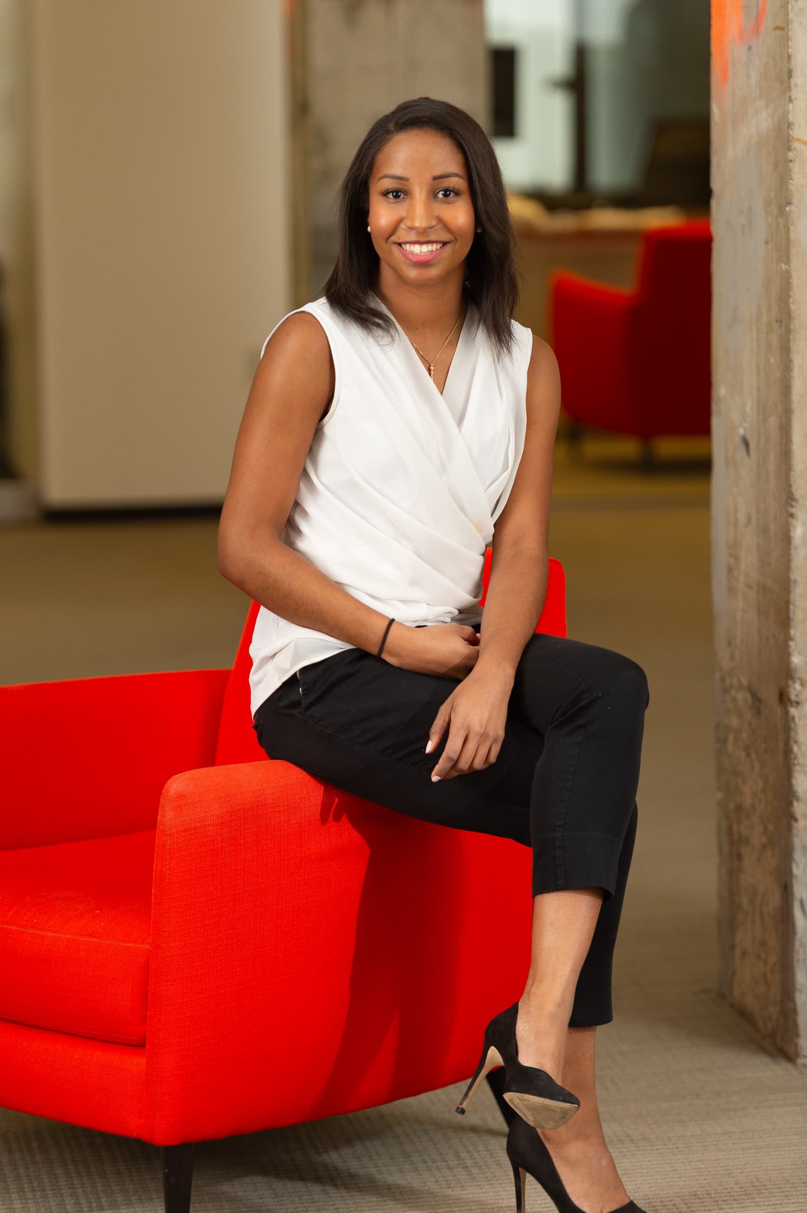 Portrait of woman with red modern furniture accent
