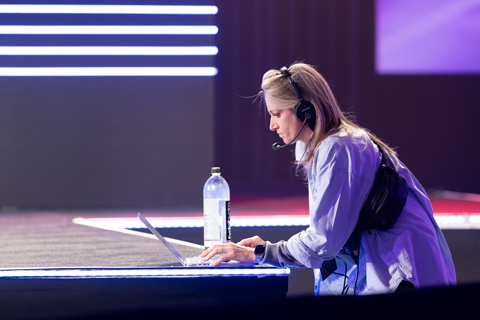 Show producer working from the stage during keynote rehearsal at a corporate conference