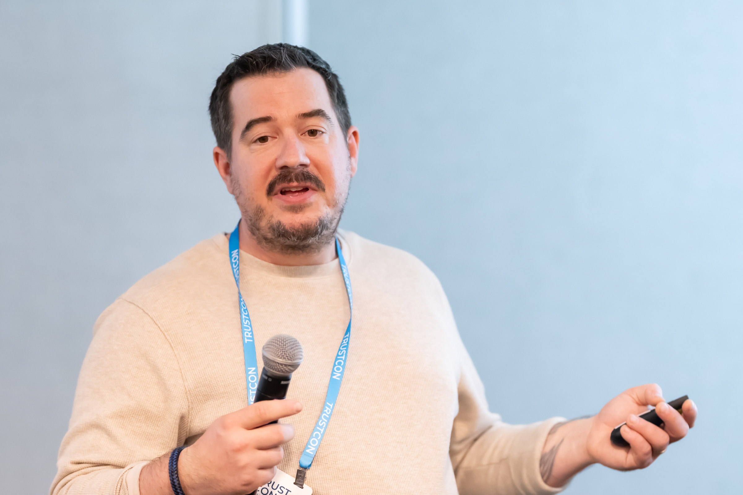 Attendee asking a question with a microphone during a breakout