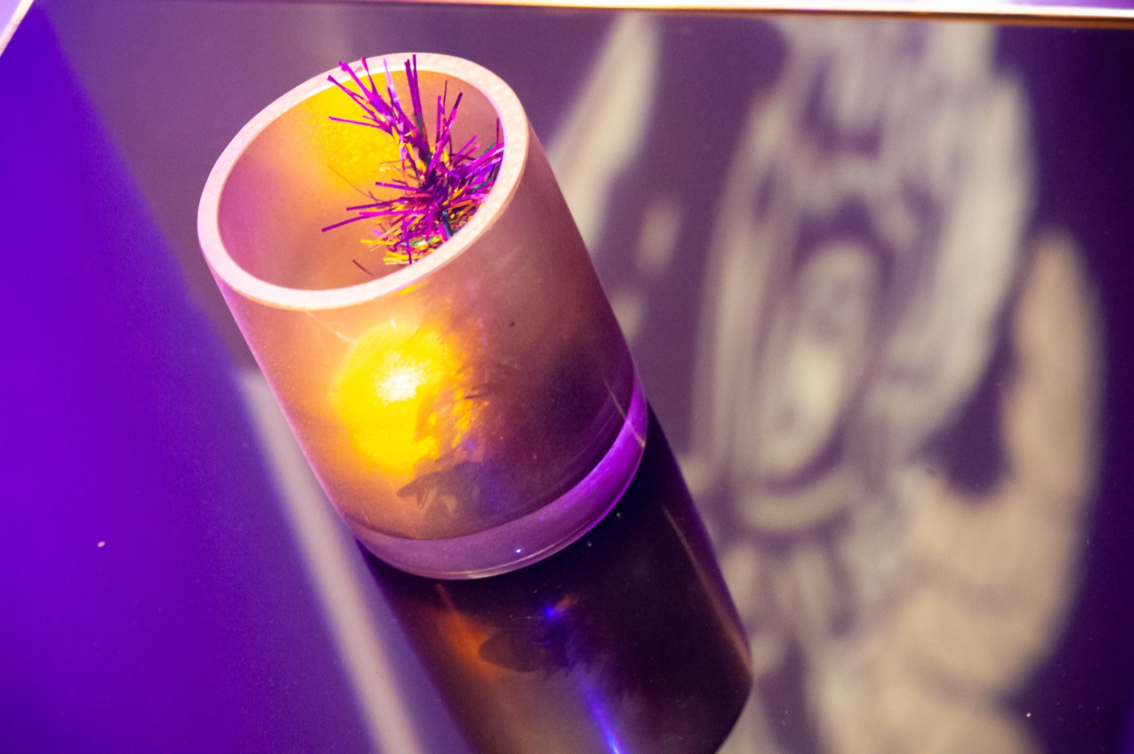 Candlelight and colored uplighting detail at a holiday party