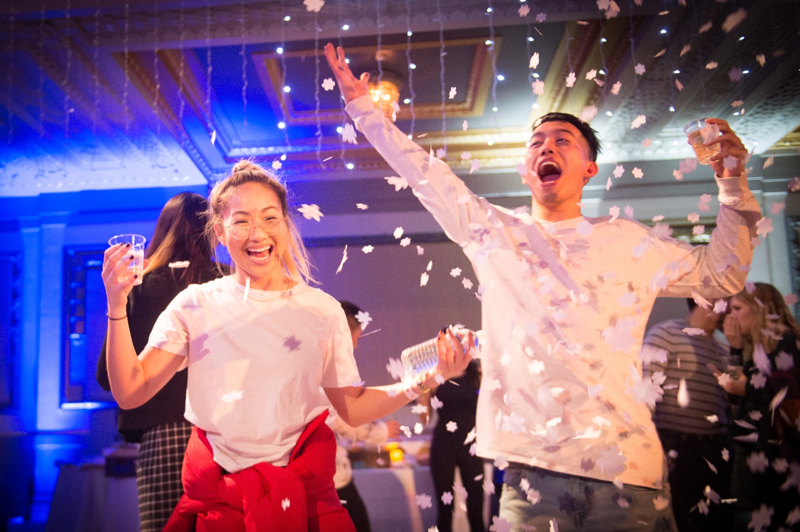 Guests celebrating with confetti at a corporate holiday party