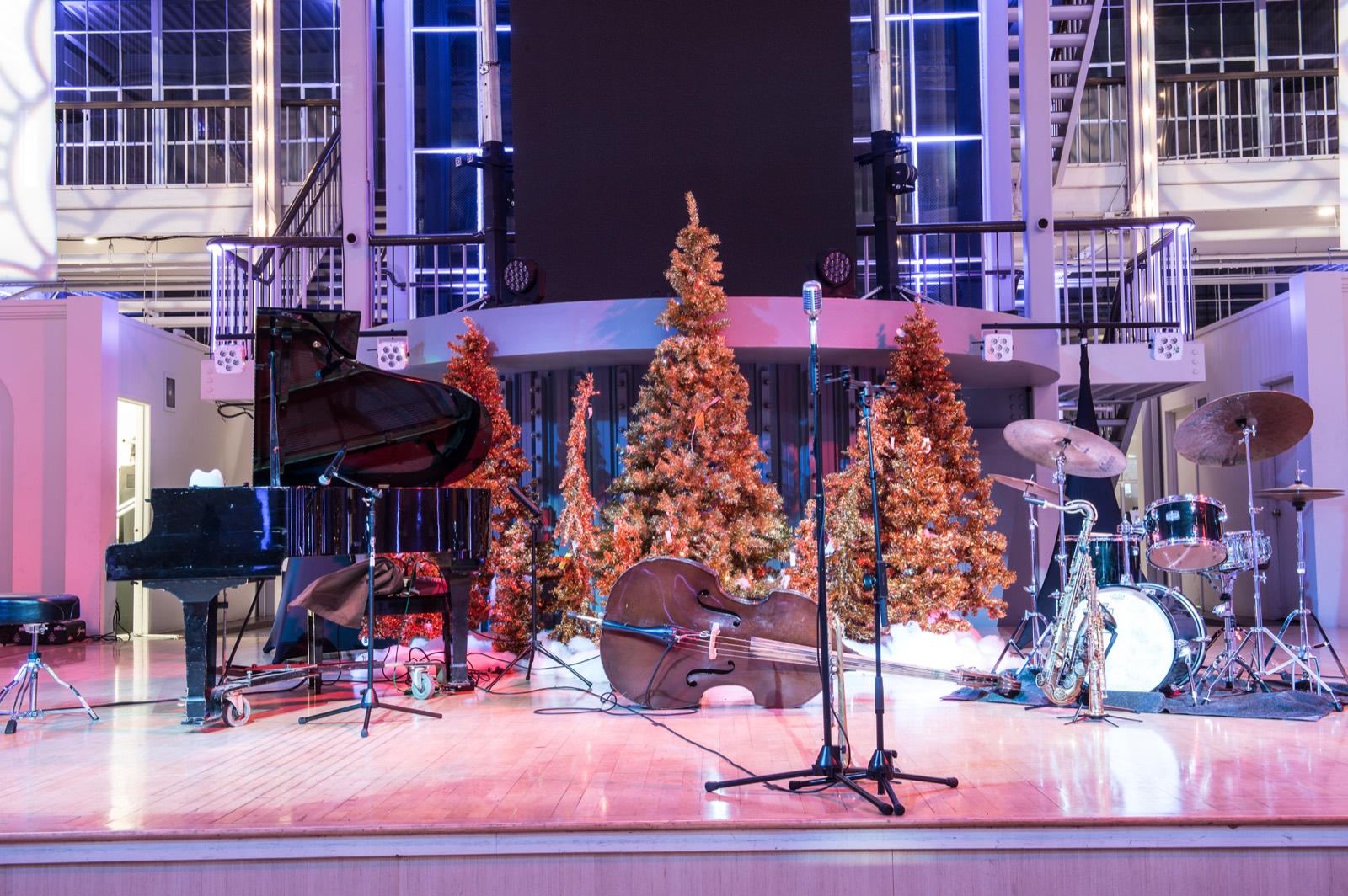 Stage with holiday trees and band equipment set before a company party