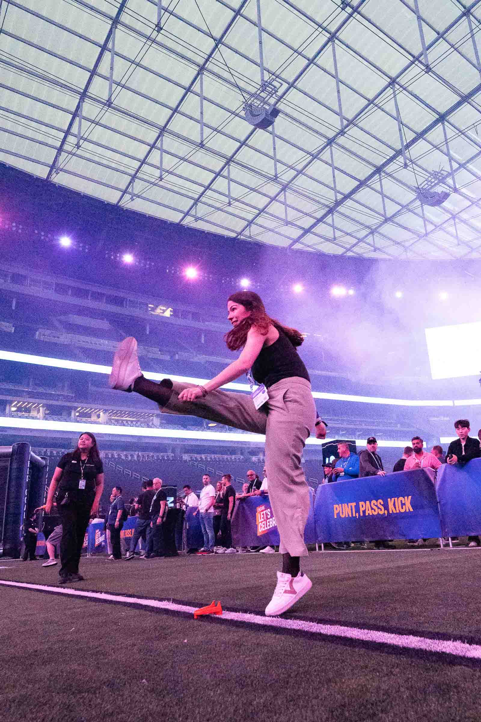 Individual performer in athletic wear executing movement in stadium venue