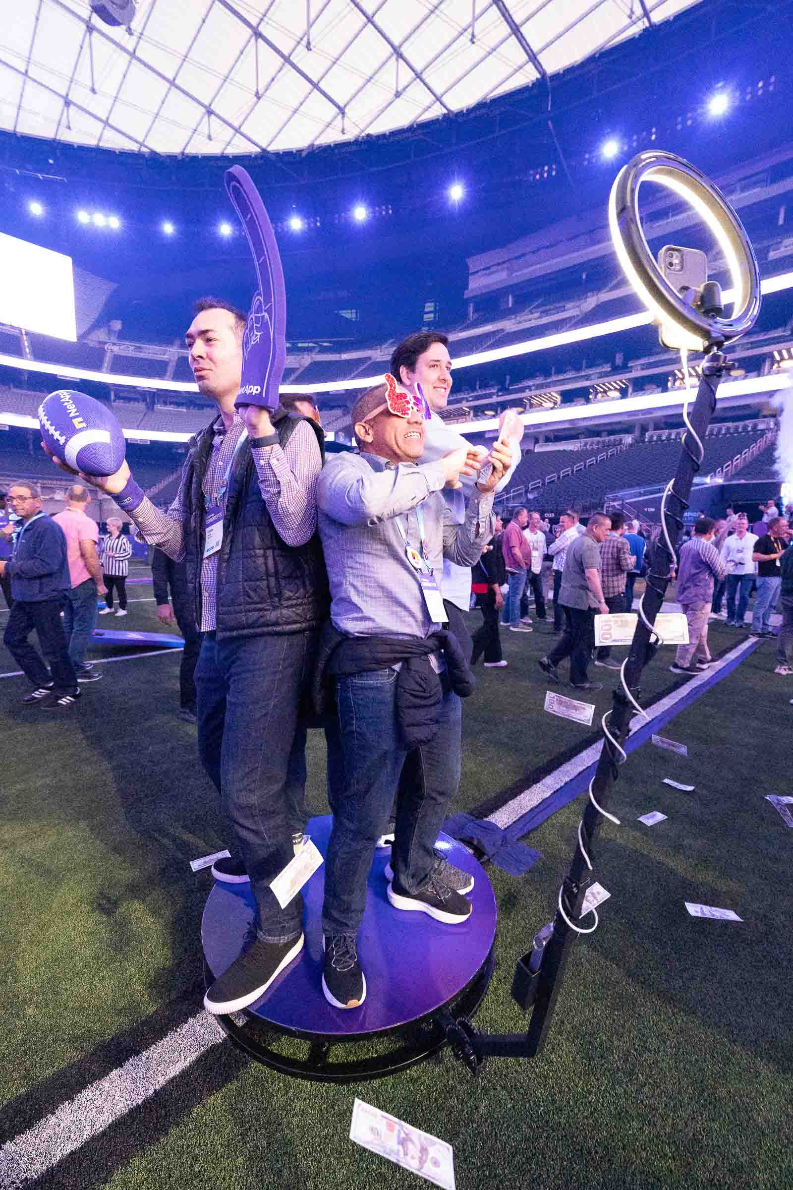 Attendees engaging with branded interactive installation in stadium venue