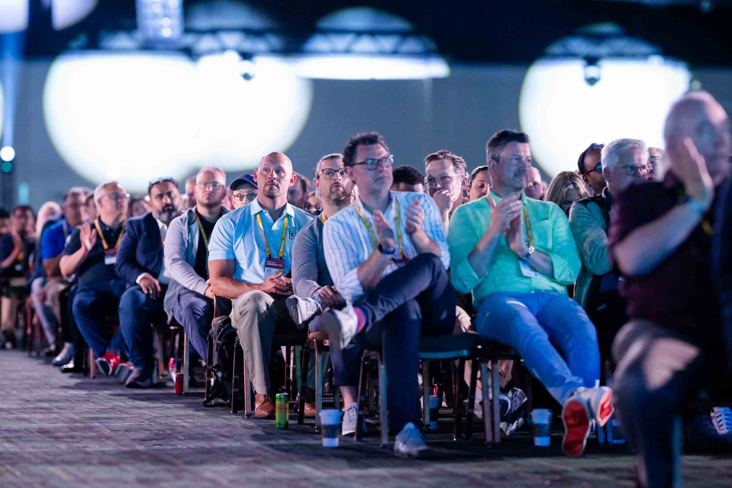 Large audience of conference attendees seated and engaged during keynote session