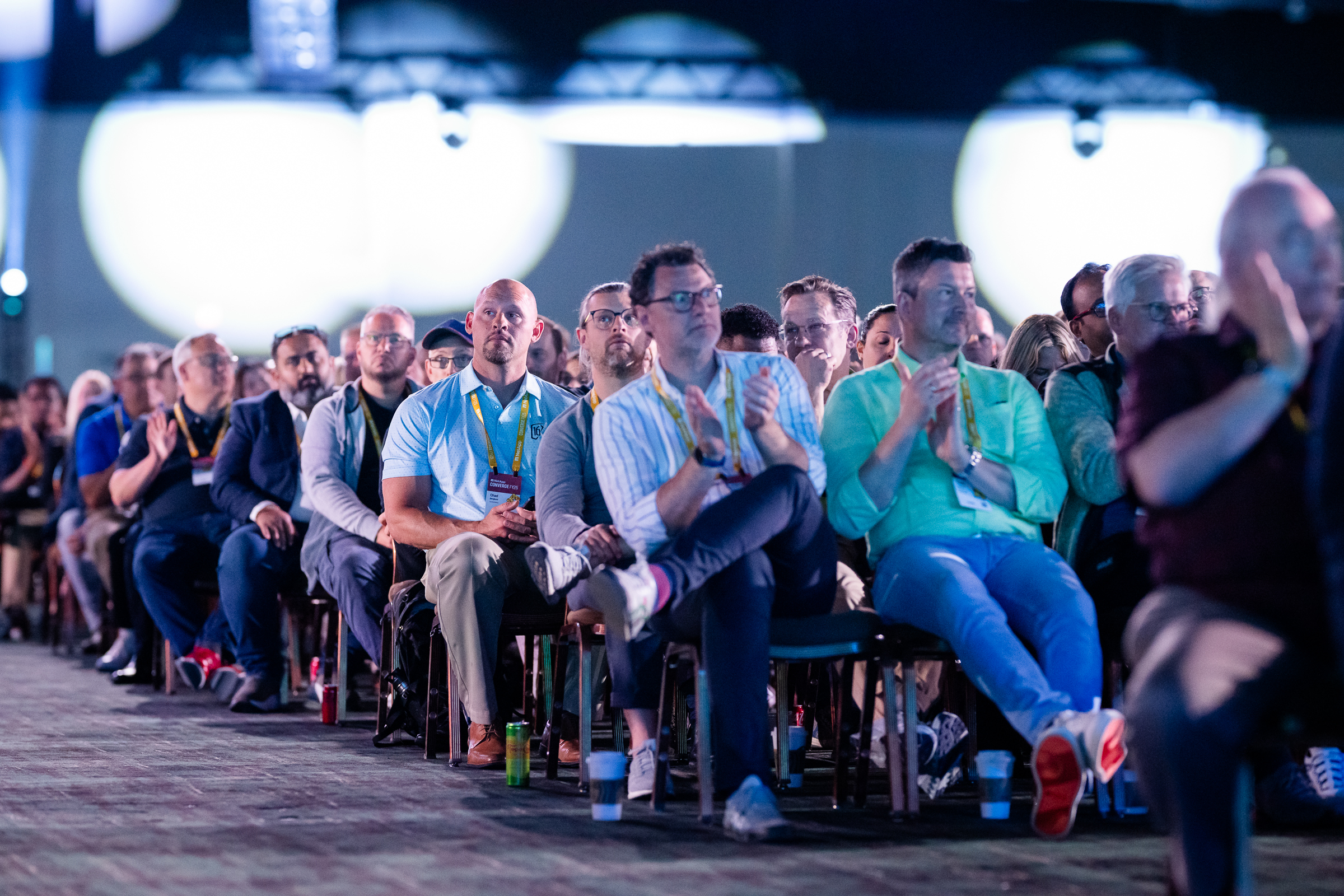 Conference attendees seated and engaged during a keynote session