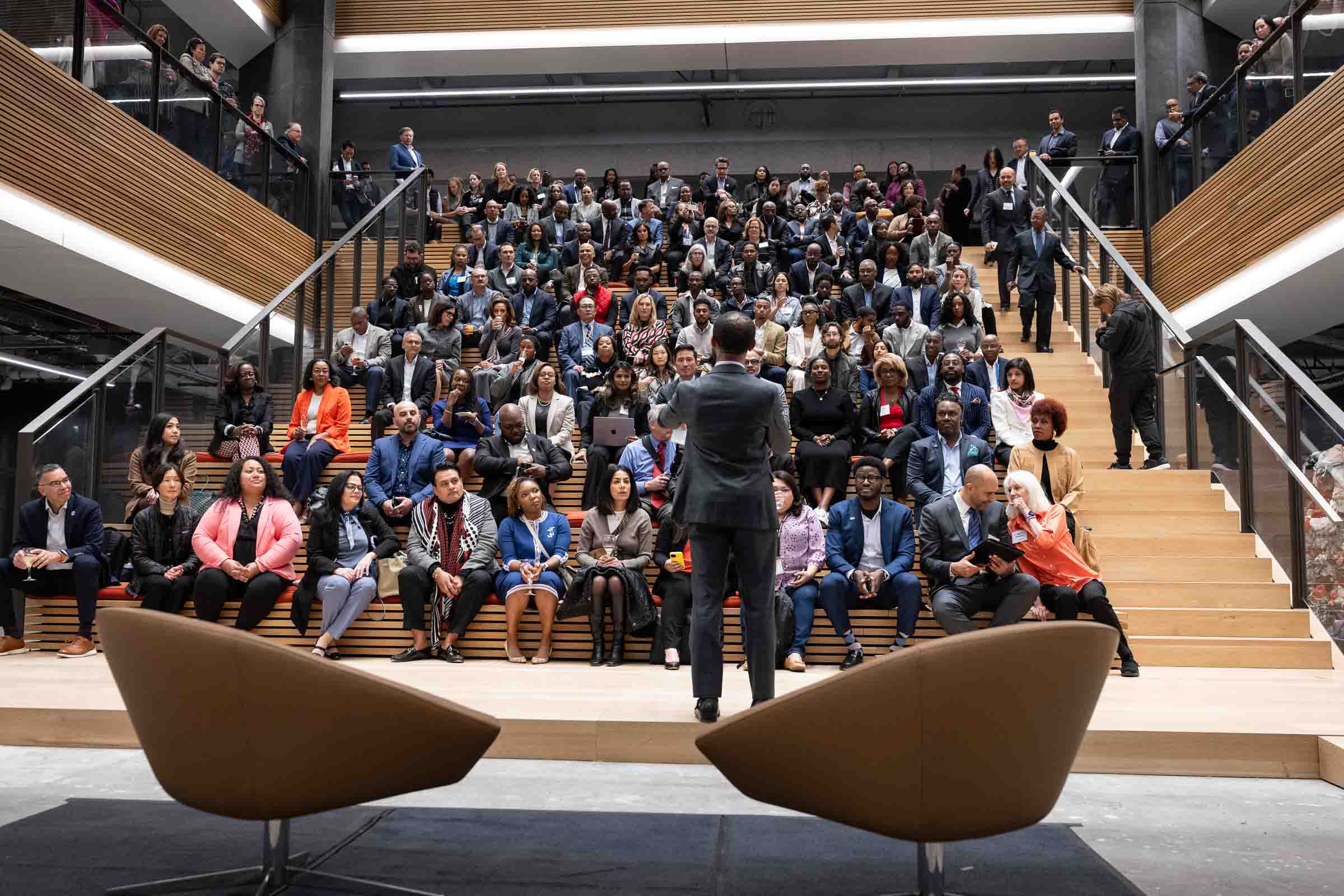 Executive presenting to an attentive audience in a San Francisco stadium-seating venue
