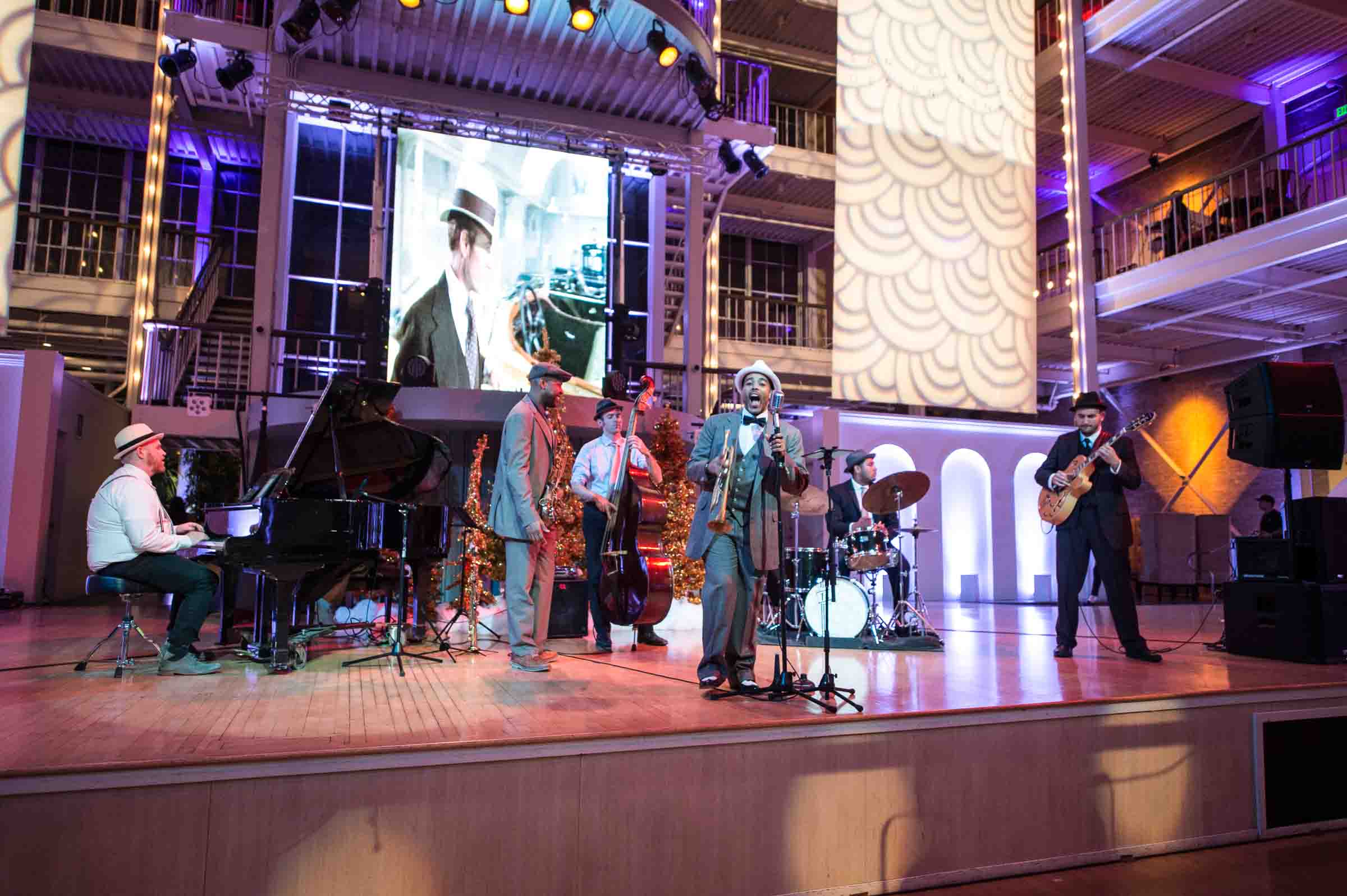 Live band performing on stage with dramatic lighting at corporate gala