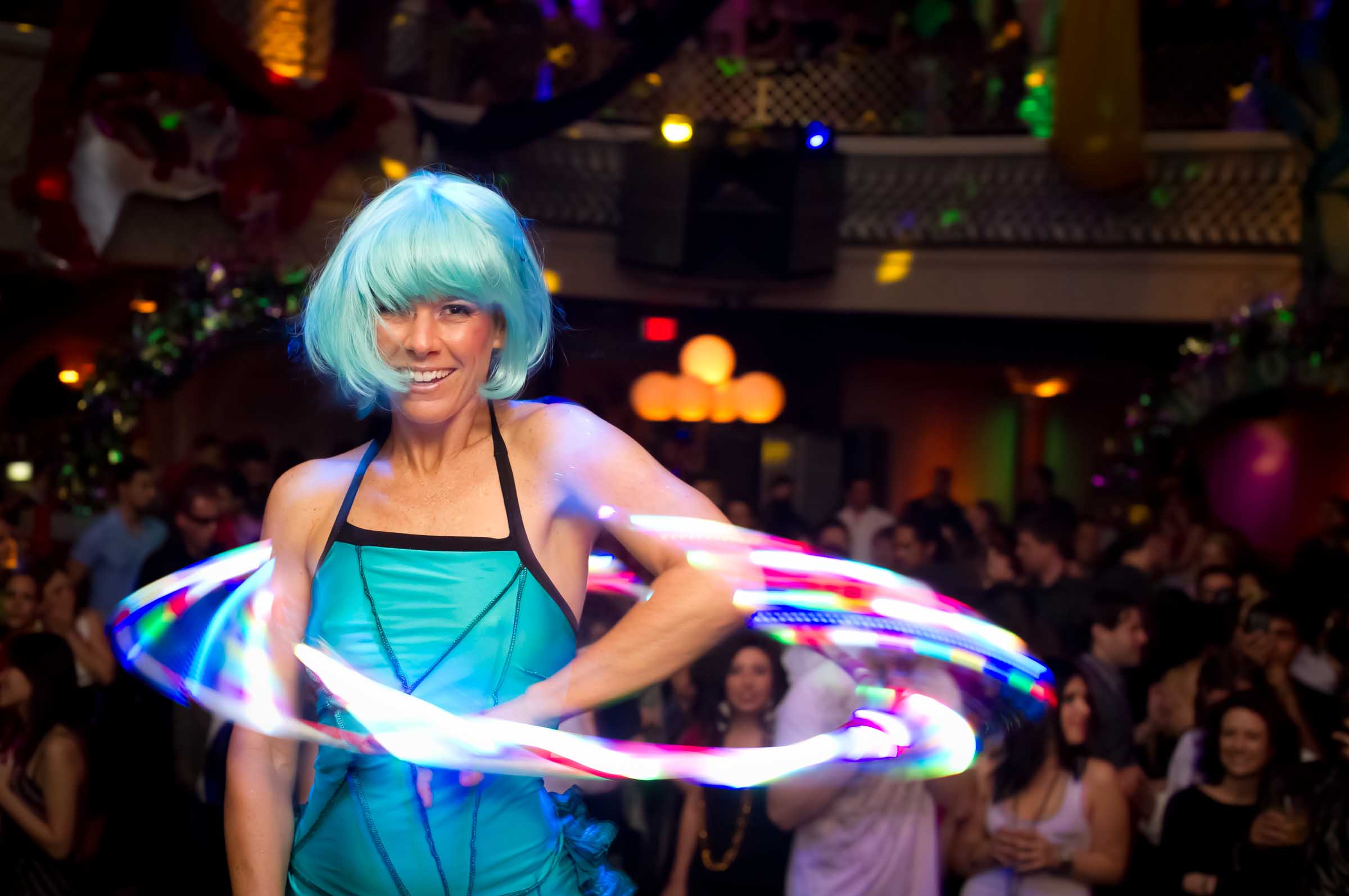 Performer with illuminated hoop entertaining crowd at gala event