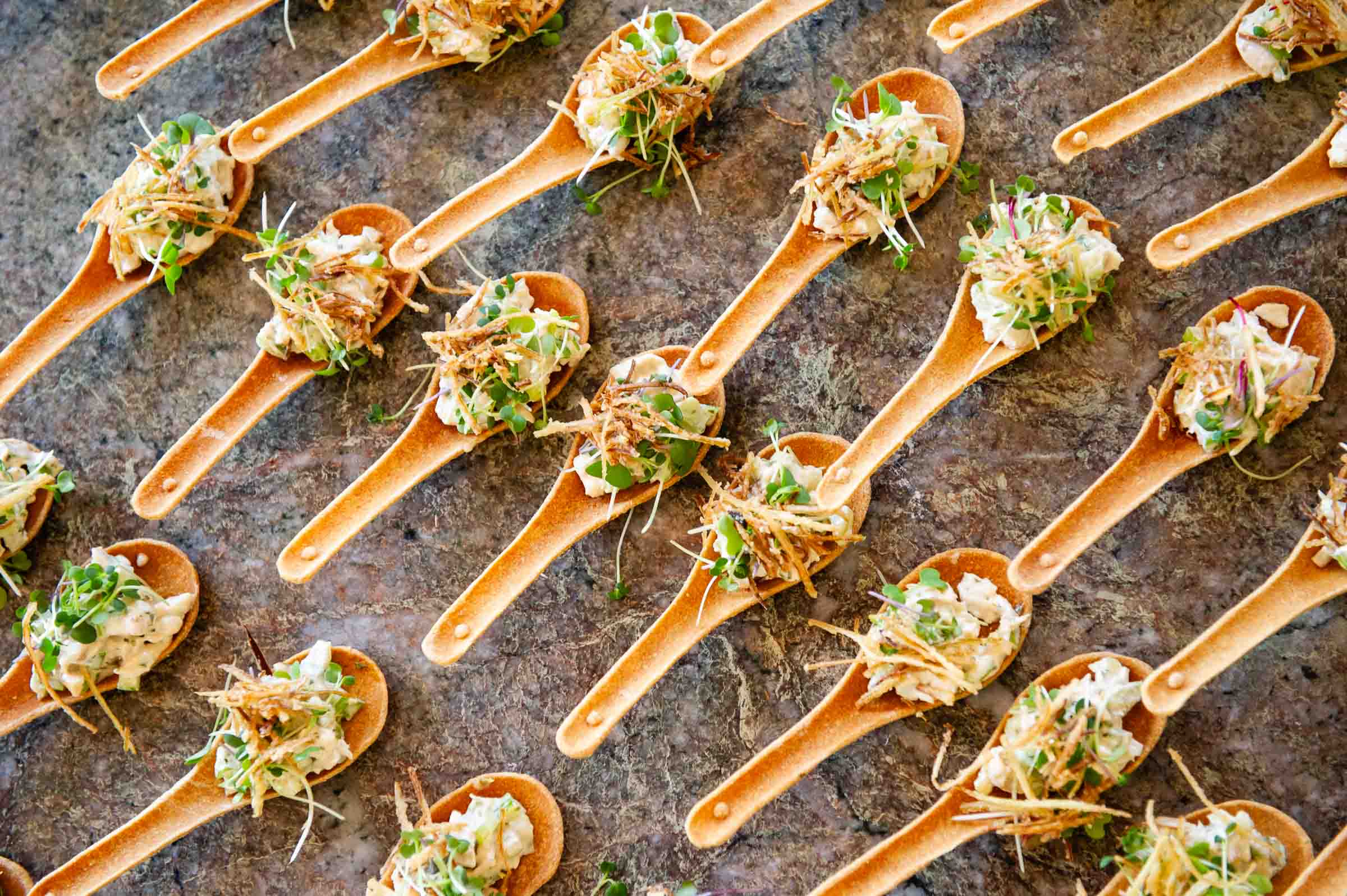 Catered spoon appetizers displayed for elegant event service