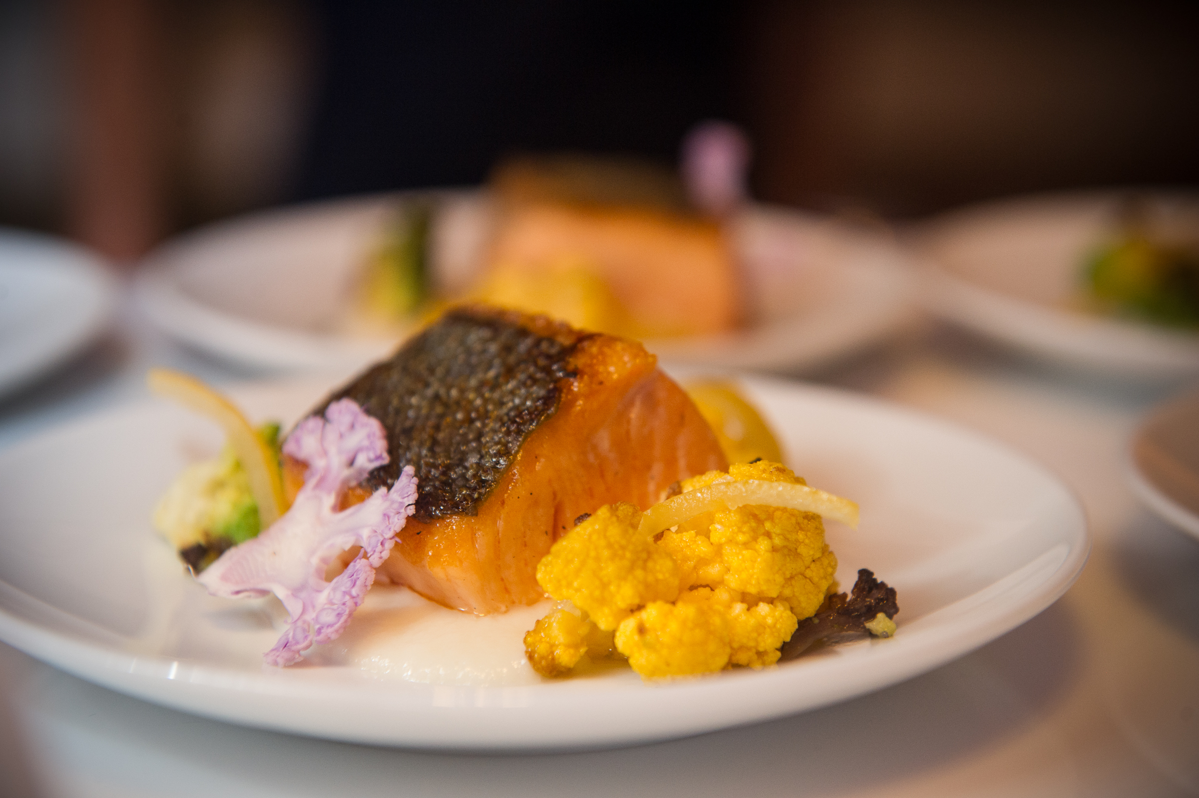Fine dining salmon course plated for a formal dinner