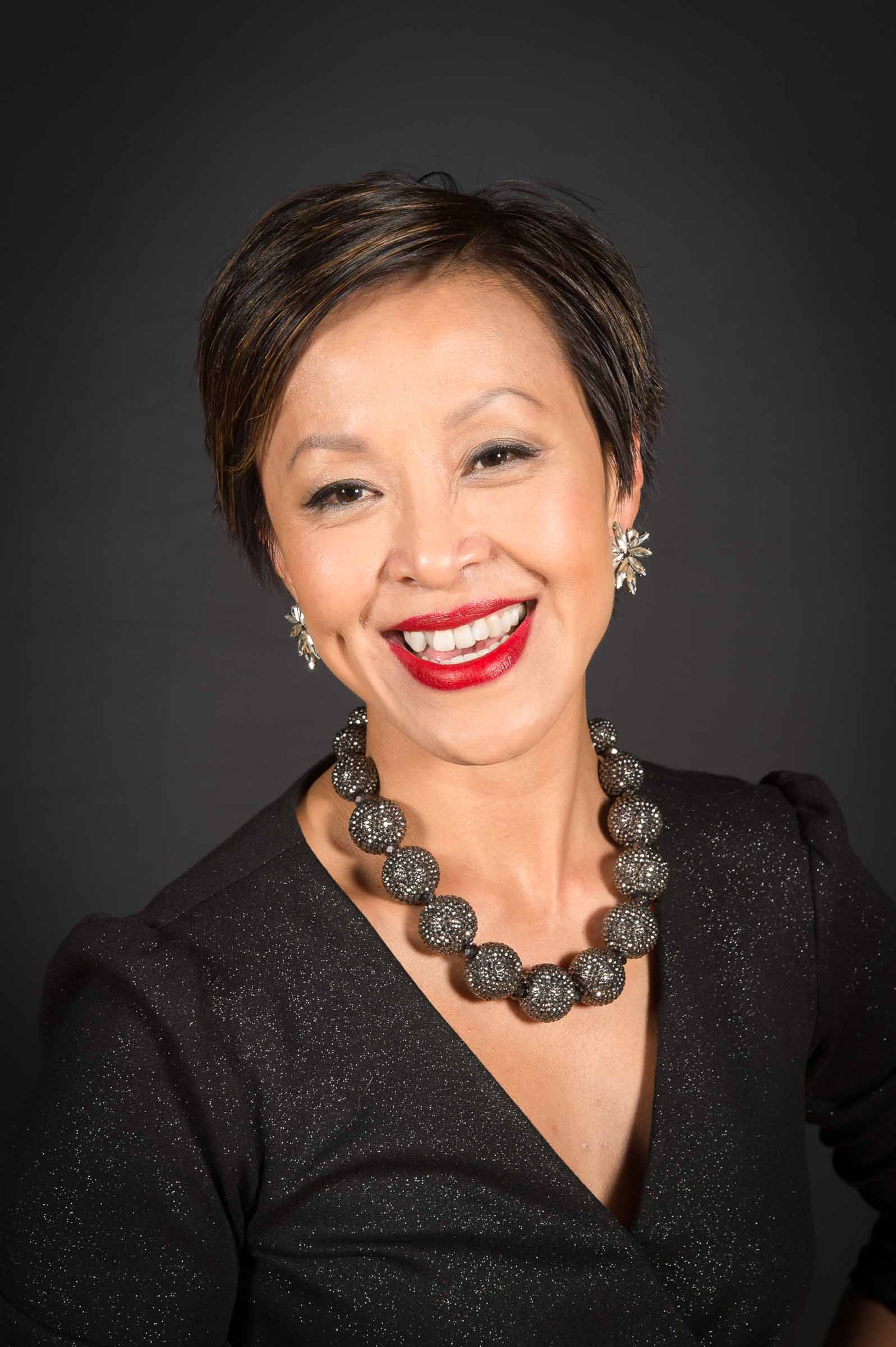 Elegant headshot featuring executive with statement necklace