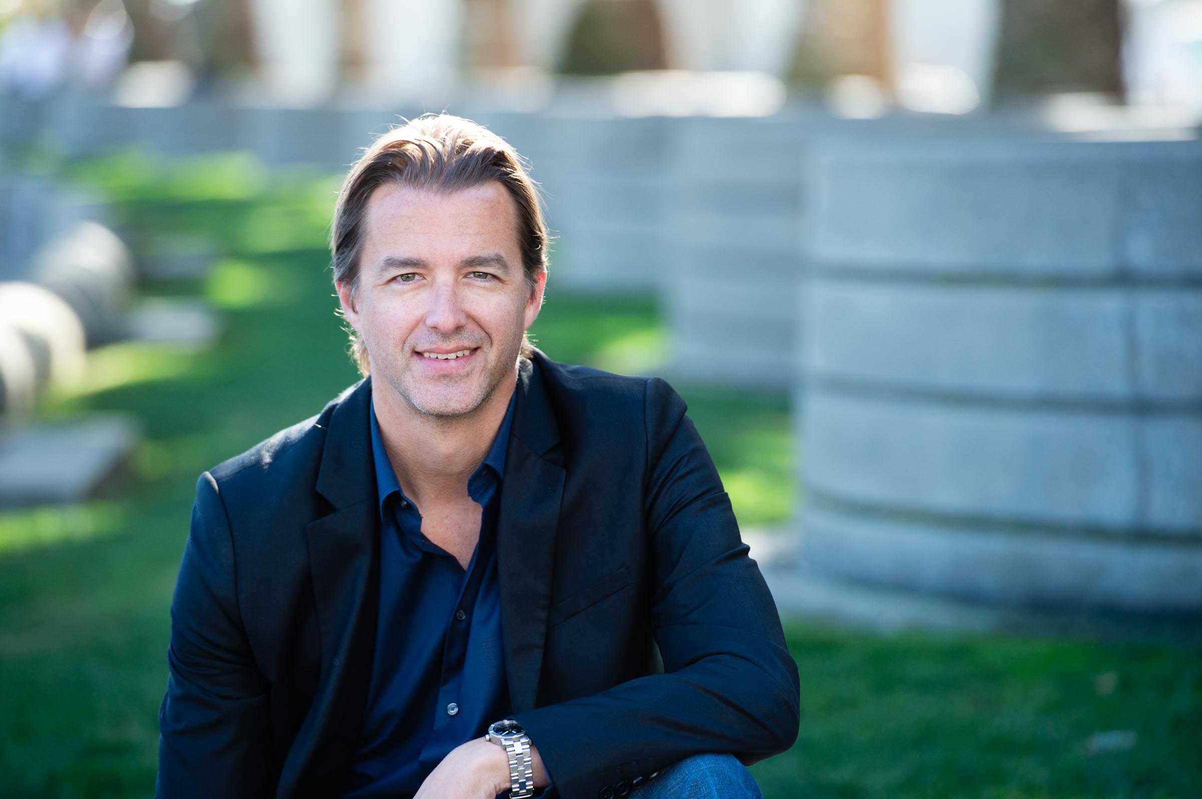 Executive portrait against vibrant green background