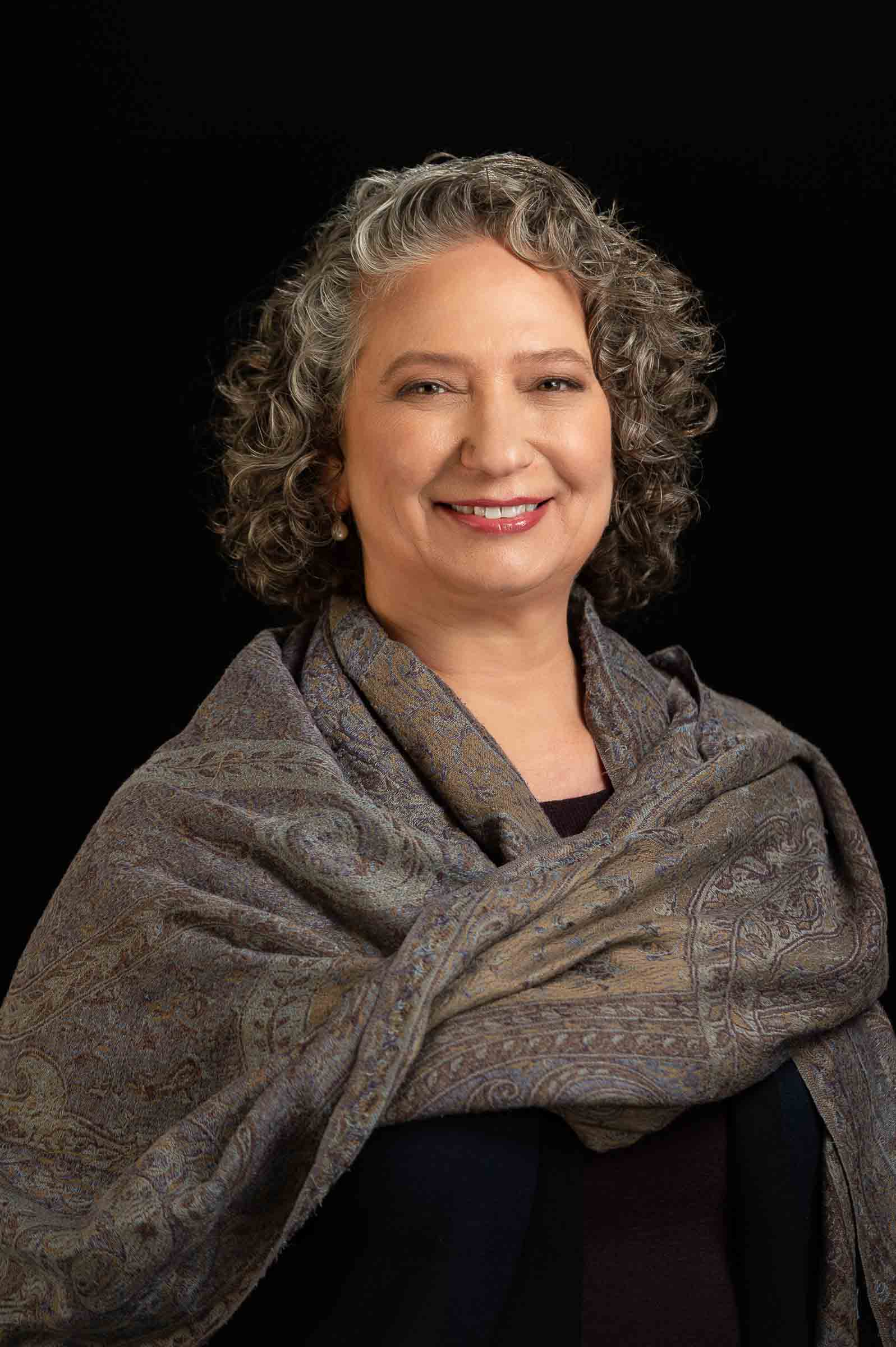 Dramatic portrait of woman against black background