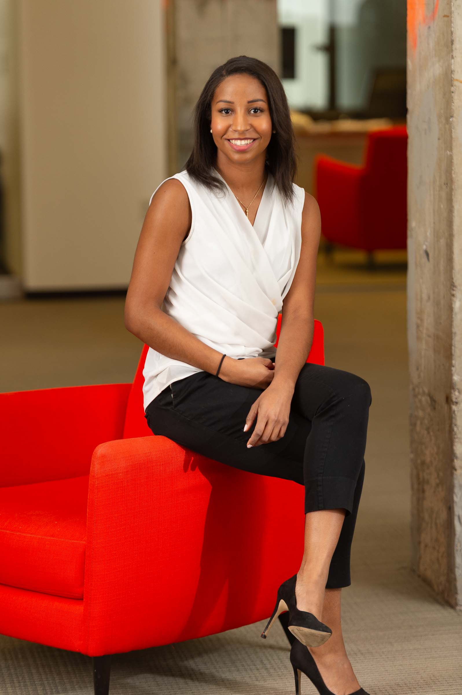 Portrait of woman with red modern furniture accent